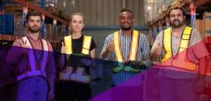 Industrial warehouse workers giving a thumbs up in a warehouse