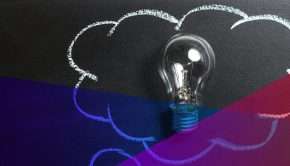 a drawing of a cloud on a blackboard, with a lightbulb in the middle
