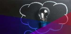 a drawing of a cloud on a blackboard, with a lightbulb in the middle