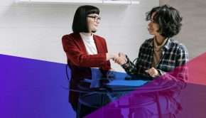 A hiring manager shaking hands with a candidate