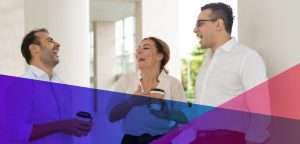 a group of employees having a friendly conversation in the workplace