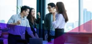 a group of coworkers talking in an office setting